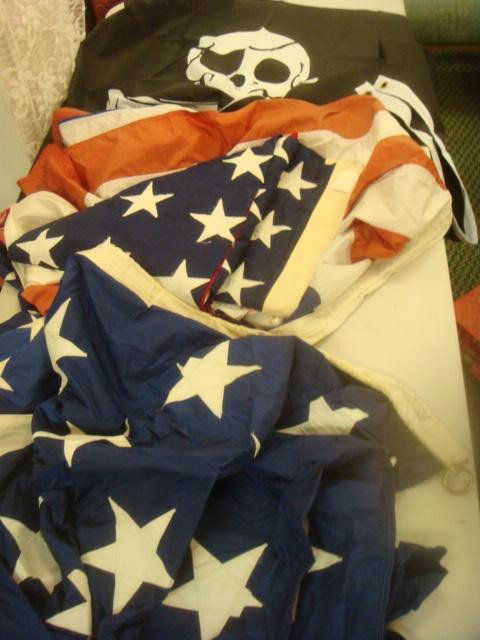 US Navy Flags Ensigns, Blue Union Jack & Pirate Fl: US Navy Flags Ensigns, Blue Union Jack & Pirate Flag From USS Austin Final Cruise. US Flags and Jack are6 Frayed. Pirate Flag has Skull and Cross Bones. (100-250)