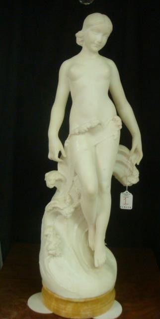 Alabaster Nude APHRODITE, Sea Maiden on Marble Plint: Alabaster Nude Sea Maiden on Marble Plinth: 26T Overall. Suspended Nude Female Held up by Crest of Wave Which Discretely Covers Her. Caramel Colored Round Beveled Base. Pin Point Gray Paint Flecks on