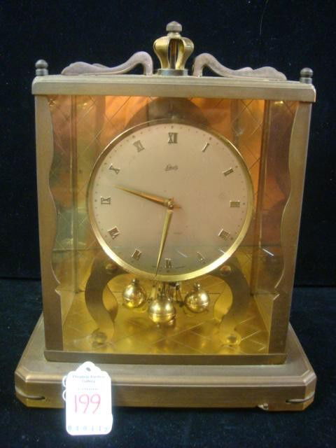SCHATZ German 1000 Day Clock in Brass Case: SCHATZ German 1000 Day Clock in Brass Case: Circa 1950's. London Coach Style, Regent Model. Rectangular Base with Glass Panels. 4 Ball Pendulum, 10 Rotations Per Minute. 8" X 10" (100-200)