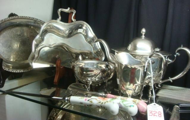 Ten Silver-plate Serving Pieces:: Ten Silver-plate Serving Pieces: Pairpoint Teapot, Sugar and Creamer, 9 1/2" Oval Tray, 2 Crumb Catchers, Cake Breaker, Cake Knife and 2 Cheese Servers with Porcelain Handles. (100-200)
