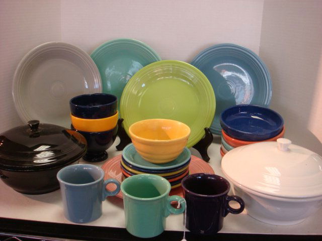Twenty One Pieces of New Fiestaware and Go Along: Twenty One Pieces of New Fiestaware and Go Along: Includes Bauer Bowl, 3 Footed USA Bowls, 7 Saucers, 2 Covered Bowls, 5 Dinner Plates, 3 Tom & Jerry Mugs. (60-100)