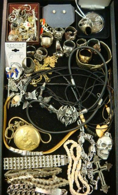 Collection of Men's Costume Jewelry: Collection of Men's Costume Jewelry: Silvertone Skeleton Rings and Necklaces, Singles and Pairs of Pierced Earrings, Bicycle Chain Bracelets, Crosses, Oakland Raiders Sterling Coin, Eagle Bracelet, Lu