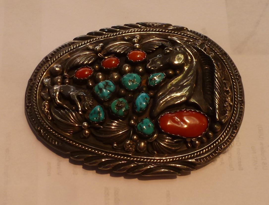 Sterling Red Co and Turquoise Navajo Belt Buckle:: Sterling Red Co and Turquoise Navajo Belt Buckle: Impressed HM Sterling. Has ER Seward Scratched in-which May Have Been the Owner. Has Raised Horse Head and Leaves. 3 3/4" Wide. (400-600)