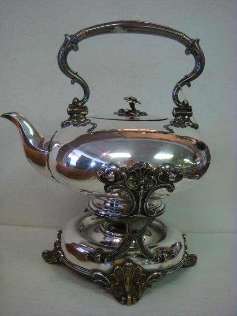 ELKINTON & CO British Silver-plate Teapot and Stan: ELKINTON & CO British Silver-plate Teapot and Stand: Squat Teapot is 6 1/2"T. Swing Handle with Ivory Insulators. Flower Finial on Hinged Lid. Engraved Elk Head Under Handle. Stand with Burner is 6 3/