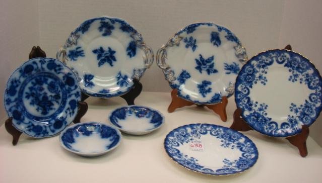 Flow Blue Plates and Fruit Bowls: Flow Blue Plates and Fruit Bowls: Two SCH L "Daisy" 7 1/8" Plates, Two Double Handled 7 3/4" Plates with Impressed "Improved Stone China" (1 Cracked), Johnson Bros "Hollat" 6 1/4" Plate (Star Crack) a