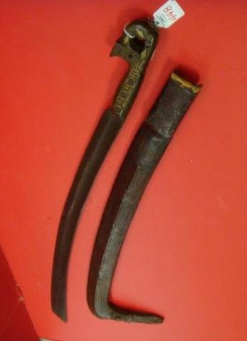 North African Style Cutlass with Carved Handle:: North African Style Cutlass with Carved Handle: Hand Tooled Hard Leather Scabbard with Duck Bill End. Wooden Handle is Inlayed with Metal Decoration. 32 1/2" LOA with 25 1/2" Blade with Long Blood Gro