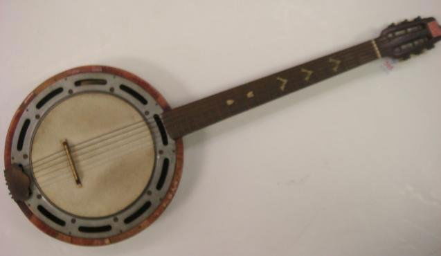 GAMBINO Genova 6 String Banjo: GAMBINO Genova 6 String Banjo: 38"L. Circular Rimmed Pot is 13 3/4" Diameter. Mother of Pearl Inlay Down Neck, Fingerboards, Around Frame and Bottom. 6 Turning Pegs. Inlaid Black Cat on Bottom. Makers
