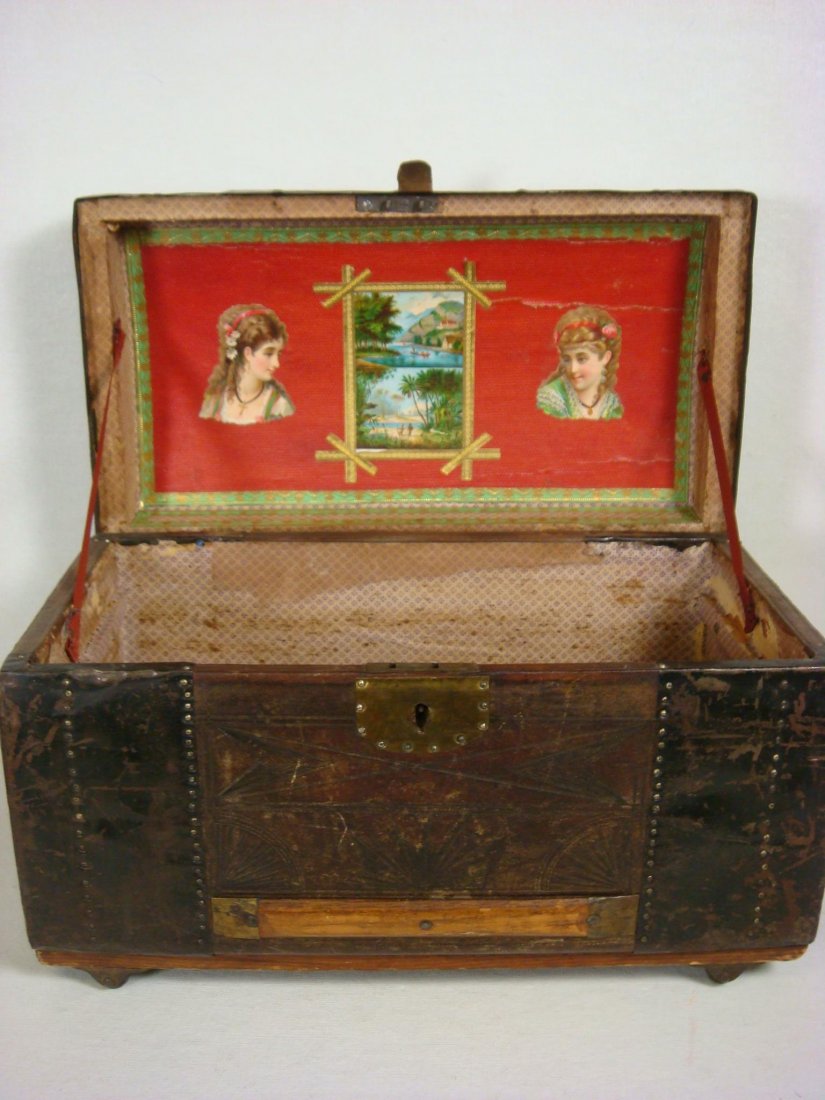 Metal Paneled Wooden Miniature Trunk:: Metal Paneled Wooden Miniature Trunk: Modified Camel Back with Incised Metal Insets and Nail Head Trim. On Rolling Metal Wheels. Paper Lined Interior with Decals. No Key or Till. 15 1/2"W X 9"D X 9"T.