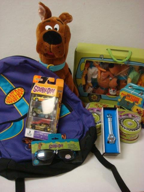 SCOOBY DOO Memorabilia Collection: SCOOBY DOO Memorabilia Collection: Scooby Doo Lunch Box, 3 Matchbox Cars, Back Pack, Sunglasses, Comic Books, Plush Character Toys, Wristwatch, Large and Medium Size Plush Scooby Dolls. (50-100)