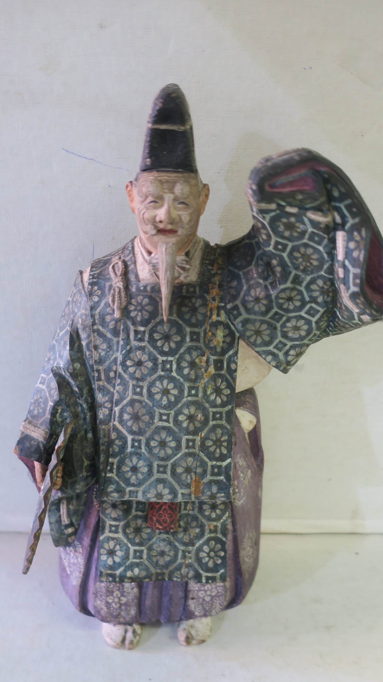 Wooden Ningen 14"T Costume Doll of Hoh Actor:: Wooden Ningen 14"T Costume Doll of Hoh Actor: The Actor Performs the Sambaso with Fan in One Hand and Raised Left Arm. The Hand Painted Polychrome Figure Wears the Okina Style Old Man Mask to Show His