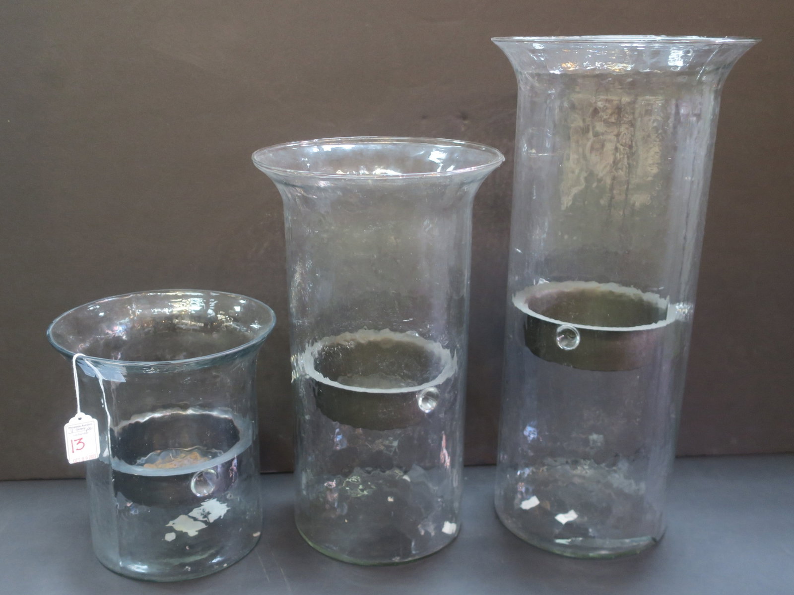 Three Italian Molded Glass Pillar Candle Holders:: Three Italian Molded Glass Pillar Candle Holders: Graduated Glass Tubes with Removable Metal Candle Holders are 9 1/4"T, 8 1/4"D; 15 1/4"T, 9 1/8"D and 19 1/4" X 9 1/8"D. Large One has Crack at Bottom