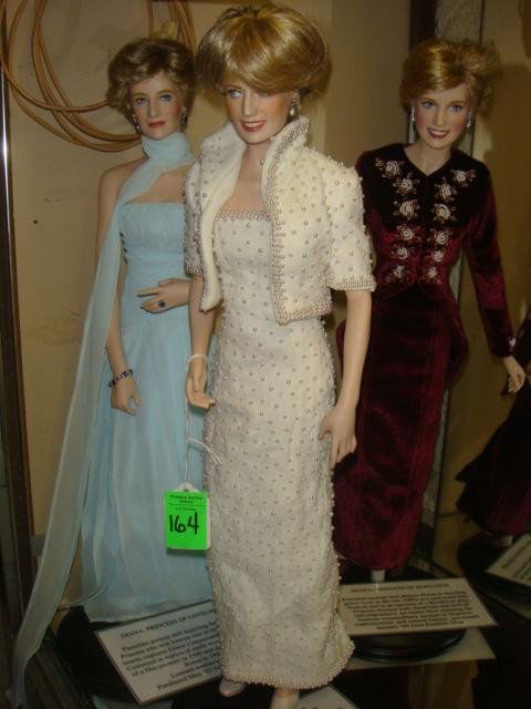 Three Porcelain Princess Diana Dolls: Three Porcelain Princess Diana Dolls: Diana of Wales, This Dress Sold at Christies. Diana of Elegance, From Broadway Play and Diana of Loveliness, Worn in Korea. 17"T with Original Boxes. From Frankli
