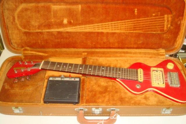 CHIQUITA Travel Guitar with Carrying Case:: CHIQUITA Travel Guitar with Carrying Case: Made by Hondo, Design of Mark Erlewine. Compact Hardwood Body in Fire Engine Red. Dimarzio Pickups. Perfect for Studio, Travel, Stage. With Amp. and Hard Tra