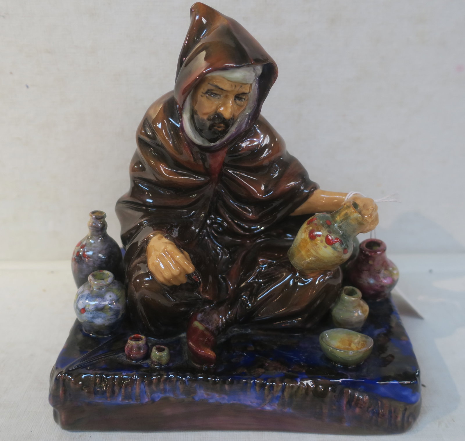 Handpainted ROYAL DOULTON "The Potter" Figurine:: Handpainted ROYAL DOULTON "The Potter" Figurine: HN 1493, 7"T X 6 3/4". Bone China Piece on Flat Base. Designed by Charles Noke (1858-1941), Produced from 1932-1992. Craftsman in Brown Robe Holding Br