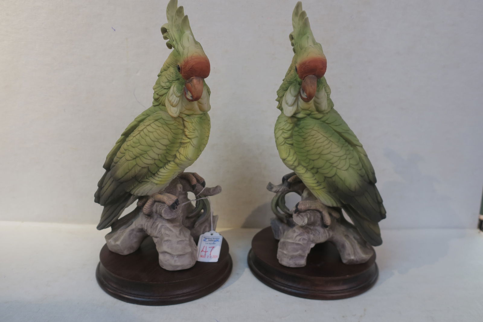 Pair of 1990's Green Cockatoos, Andrea by Sadek:: Pair of 1990's Green Cockatoos, Andrea by Sadek: 11 1/2"T Bisque Porcelain with Matte Finish on Wooden Plinth, #7132. Mirrored Pair with Curved Red Beaks, Fanned Crests & Intricate Detailing. Sadek Ne
