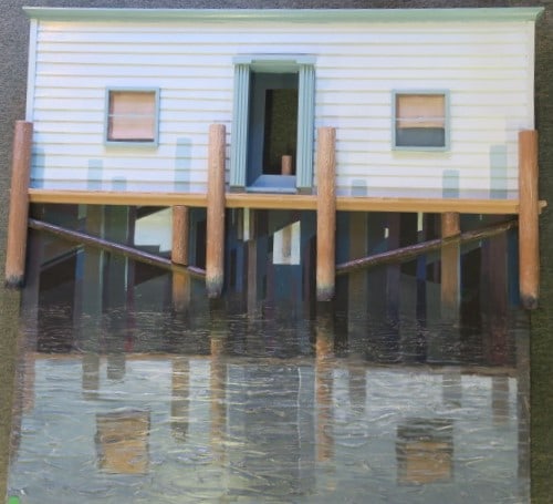 REGGIE FINKELMEN, Dimentional Acrylic on Board:: REGGIE FINKELMEN, Dimentional Acrylic on Board: He was an Ohio Artist 1921-2018. Done in 1995, Signed Lower Right, Titled Pier Pleasure. 36" Square. Lower 3/4 Shows Water Reflection of the Building an
