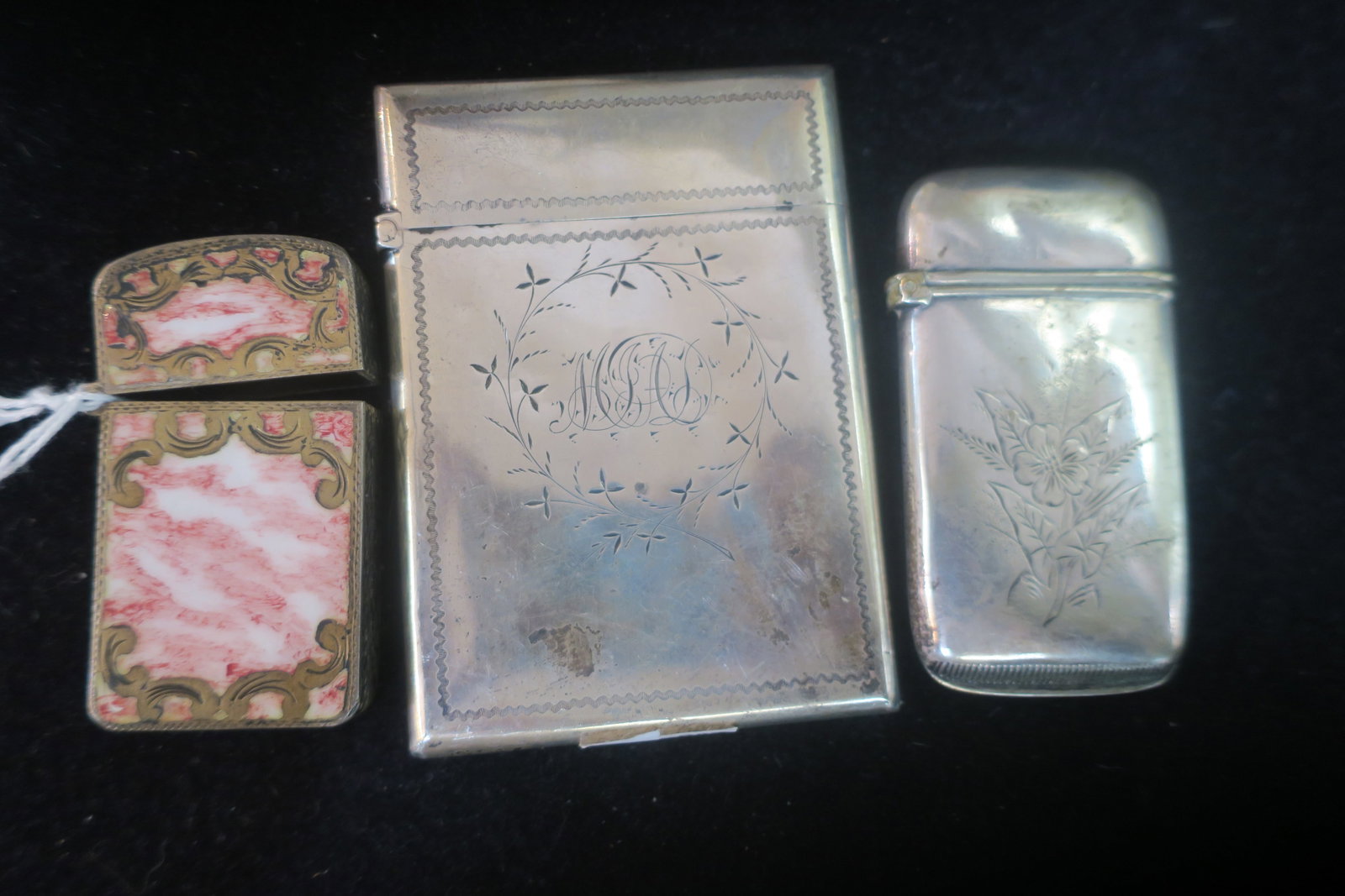 Two Antique Match Safes and Sterling Card Holder:: Two Antique Match Safes and Sterling Card Holder: Unmarked Silver Match Safe has Engraved Flowers on One Side and JML on Other. 2 3/4" X 1 1/2". 800 Silver with Gilt Safe has Pink and White Swirled En