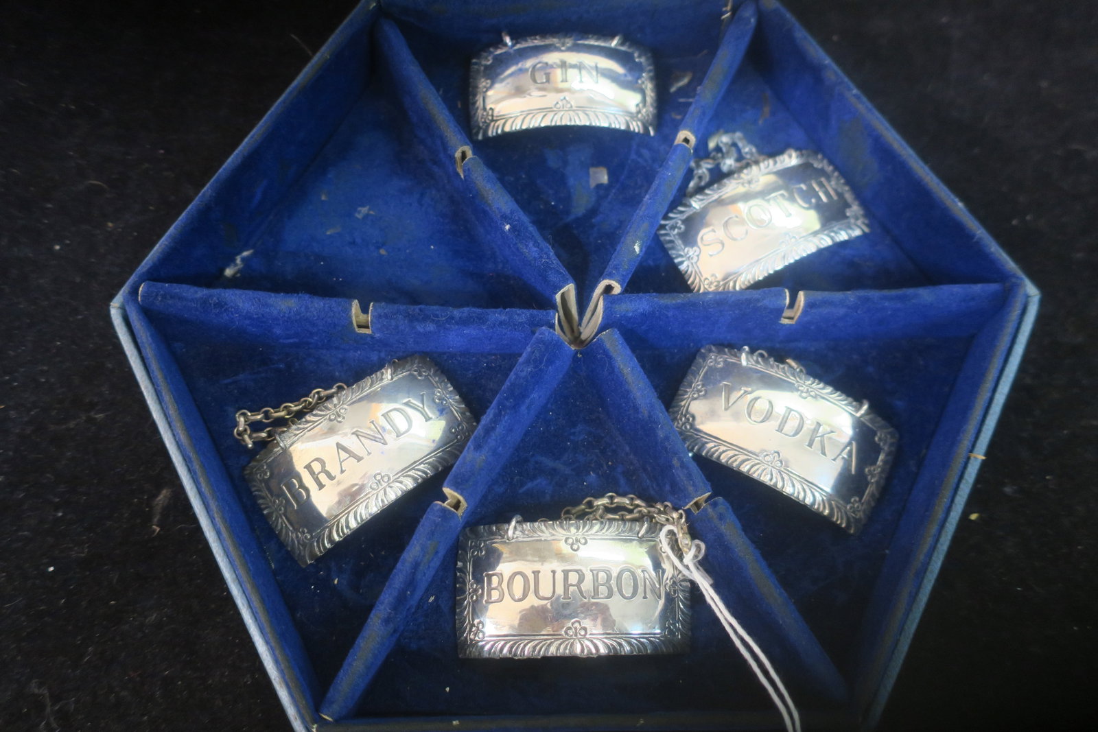Five Vintage STIEFF Sterling Silver Decanter Tags:: Five Vintage STIEFF Sterling Silver Decanter Tags: Made for Colonial Williamsburg Restoration. Includes Brandy, Gin, Scotch, Bourbon and Vodka. Missing Rum. All in Hexagonal Fitted Stieff Box. (250-40