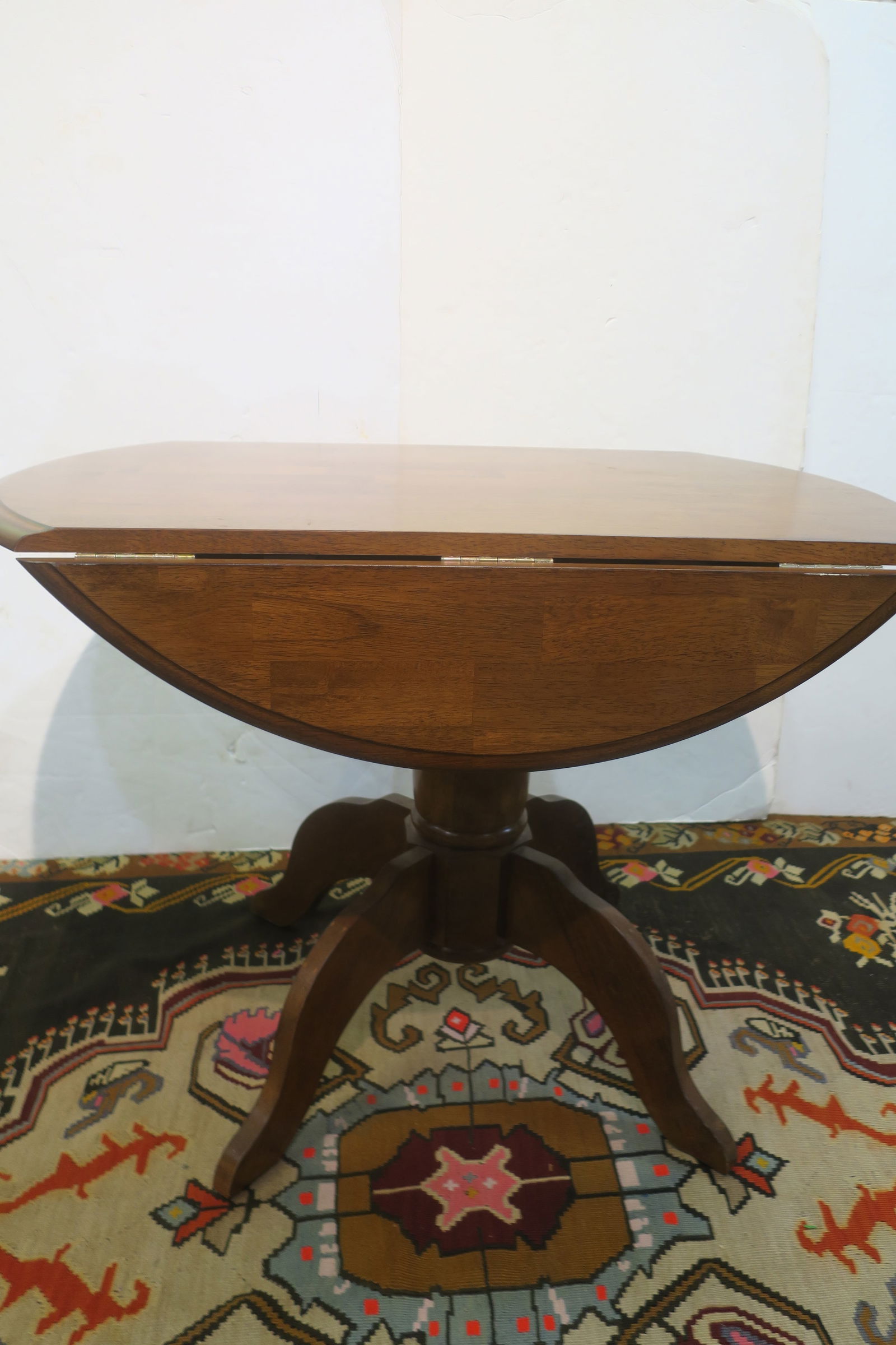 Small Round Oak Pedestal Table:: Small Round Oak Pedestal Table: Drop Leaf Sides, Beveled Edge. Four Splayed Legs. 30"T. 71 1/2" Round. (100-200)