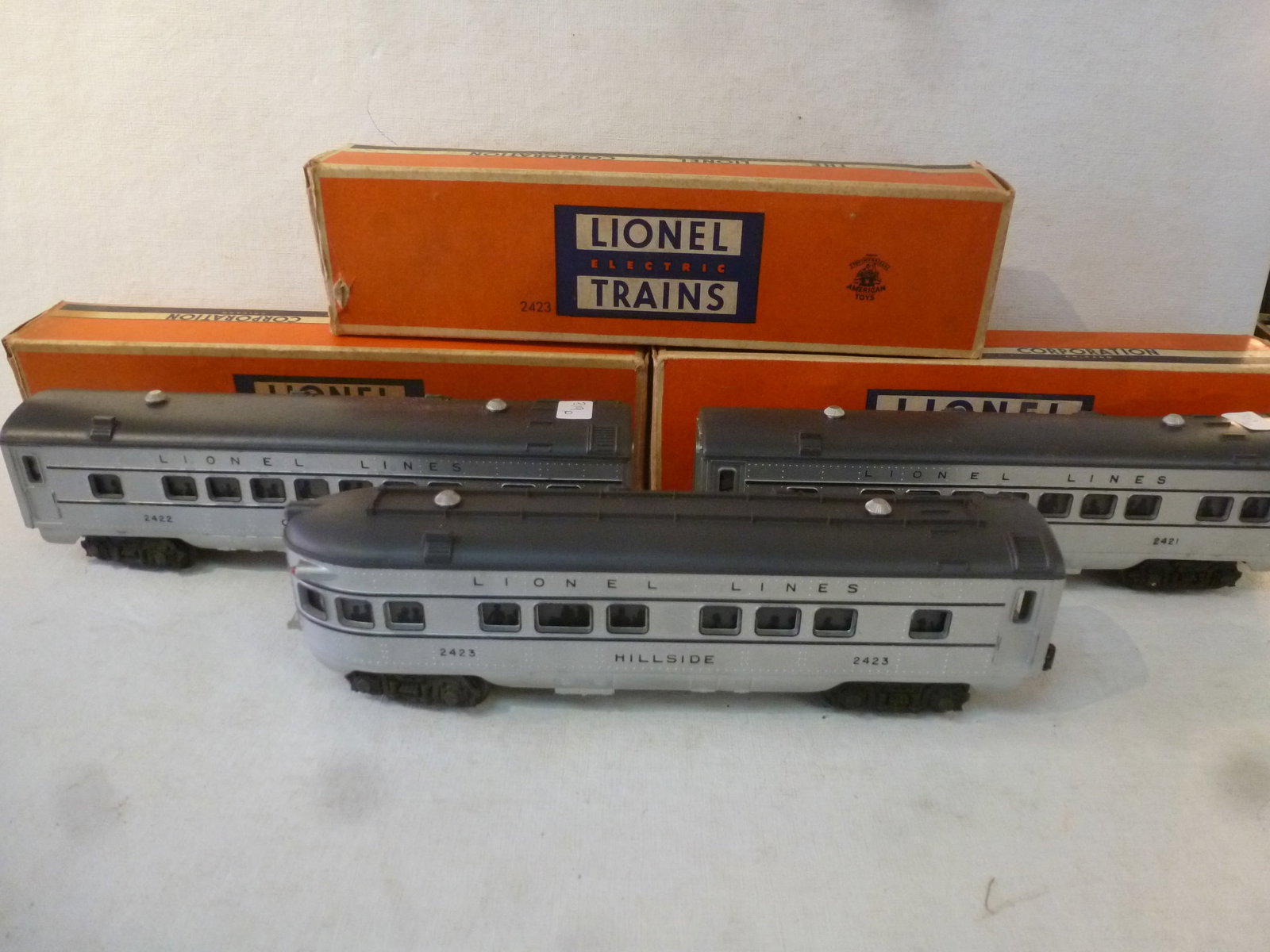 Three LIONEL TRAINS Observation and 2 Pullman Cars:: Three LIONEL TRAINS Observation and 2 Pullman Cars: Hillside Illuminated Observation Car with Revelers in the Windows No 2423. Maplewood and Chatham Illuminated Pullman Cars, Same Revelers, No 2421 an