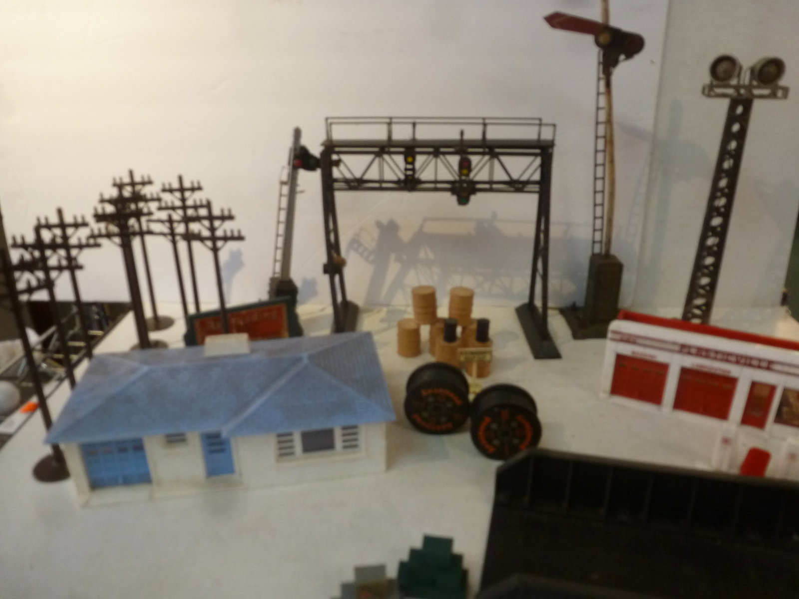 Collection of LIONEL TRAIN Accessories: Collection of LIONEL TRAIN Accessories Bill Board for Hampton Train Shop, Telephone Poles, Railroad Signs, Barrels Large Wire Reels, Plasticville Gas Station and House. Light Towers, Rail Road Overpas
