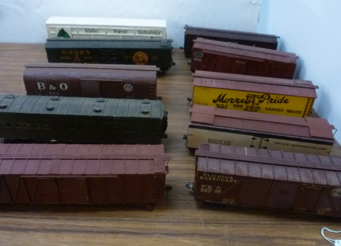 Ten O-Gauge Pre WW II, Rolling Stock Box Cars:: Ten O-Gauge Pre WW II, Rolling Stock Box Cars: Base of Wood with Metal or Painted Wood Exteriors. Idaho Forest, Texas Pacific Cattle Car, B&O, Troop Kitchen Car. Hood's Milk, NYC, Florida East Coast a