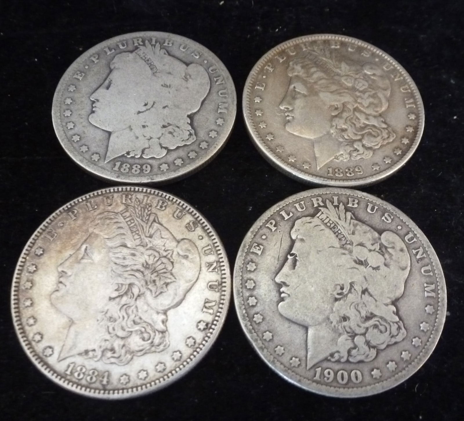 Four Circulated Morgan 90% Silver Dollars: (1 of 2)