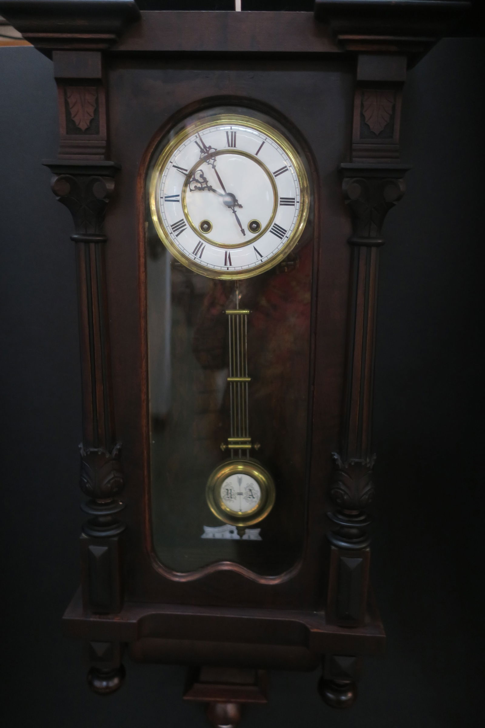 Antique Walnut German Wall Clock by Thomas Haller:: Antique Walnut German Wall Clock by Thomas Haller: Glass Front and Sides Wall Clock with Pendulum with R A on Weight. Ca 1880-1900. White Bone Face with Roman Numerals. Oak Leaf Decorations. (300-600)