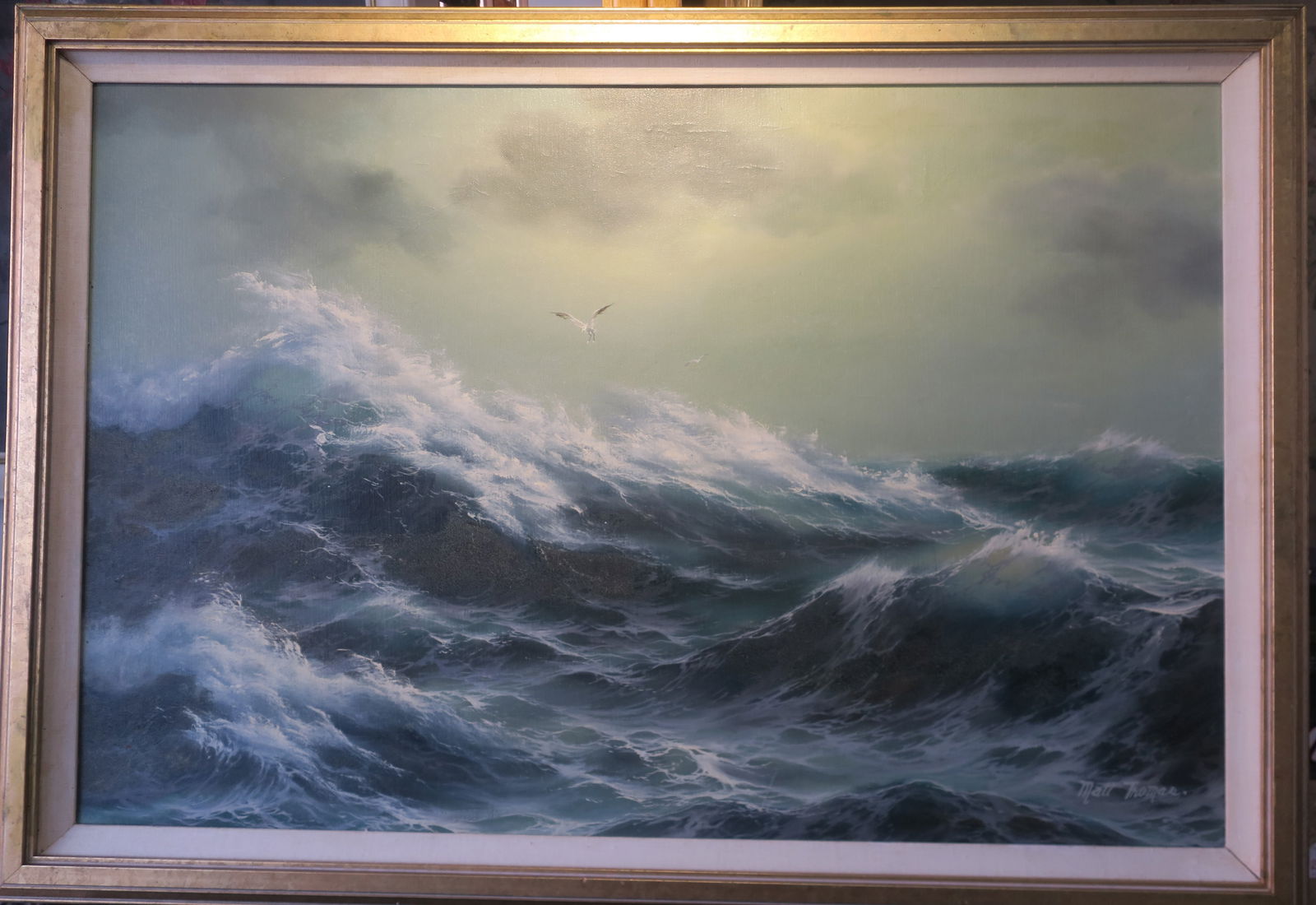 MATT THOMAS, Turbulent Seascape, Oil on Canvas:: MATT THOMAS, Turbulent Seascape, Oil on Canvas: Lone Seagull Sails over The Peaks and Rolls of Crashing Waves under an Stormy Sky. Signed LR Curlicue Forms in Paint, Framed to 41" x 27 1/2". (300-500)