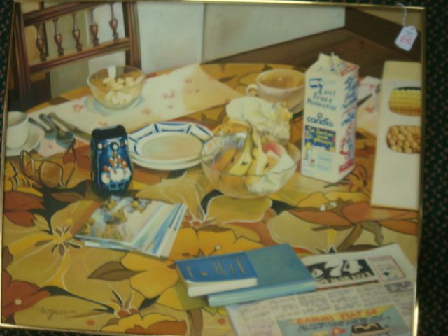Oil on Canvas Still Life, Signed BOGAERO:: Oil on Canvas Still Life, Signed BOGAERO: Floral Covered Breakfast Table Complete with Milk Carton, Newspaper, Books, Cereal, Fruit and Napkins. 30" X 24" with Narrow Gold Metal Frame. (100-200)