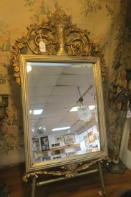 Golden and Silver Framed Mirror with Ornate Decor: