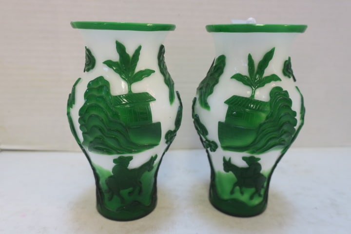Pair of Chinese Overlay Peking Glass Vases:: White Opque Glass with Bright Green Encrusted Design. The Outer Carved AwayTextured Images Depicting Mountains, Florals, Sampan, Man on Donkey, Female having Picnic. Baluster Shape, Flared Lip. 7"T.