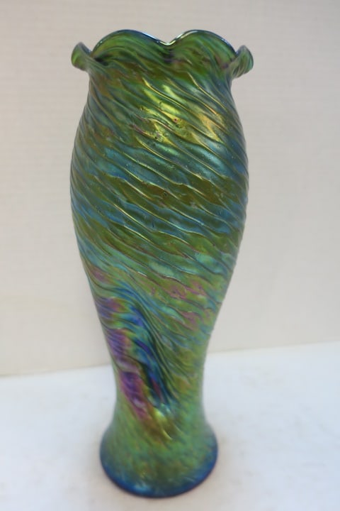 Iridescent Art Glasss Vase, Unsigned:: Possibly Rindskoph or Loetz. Applied Flattened Threading Spirals. Green Glass with Iridescent Matte Surface and Purple, Blue and Gold Bands. Triple Pinched Waist, Ruffled Rim. Ground Pontil. 13 1/4"T.