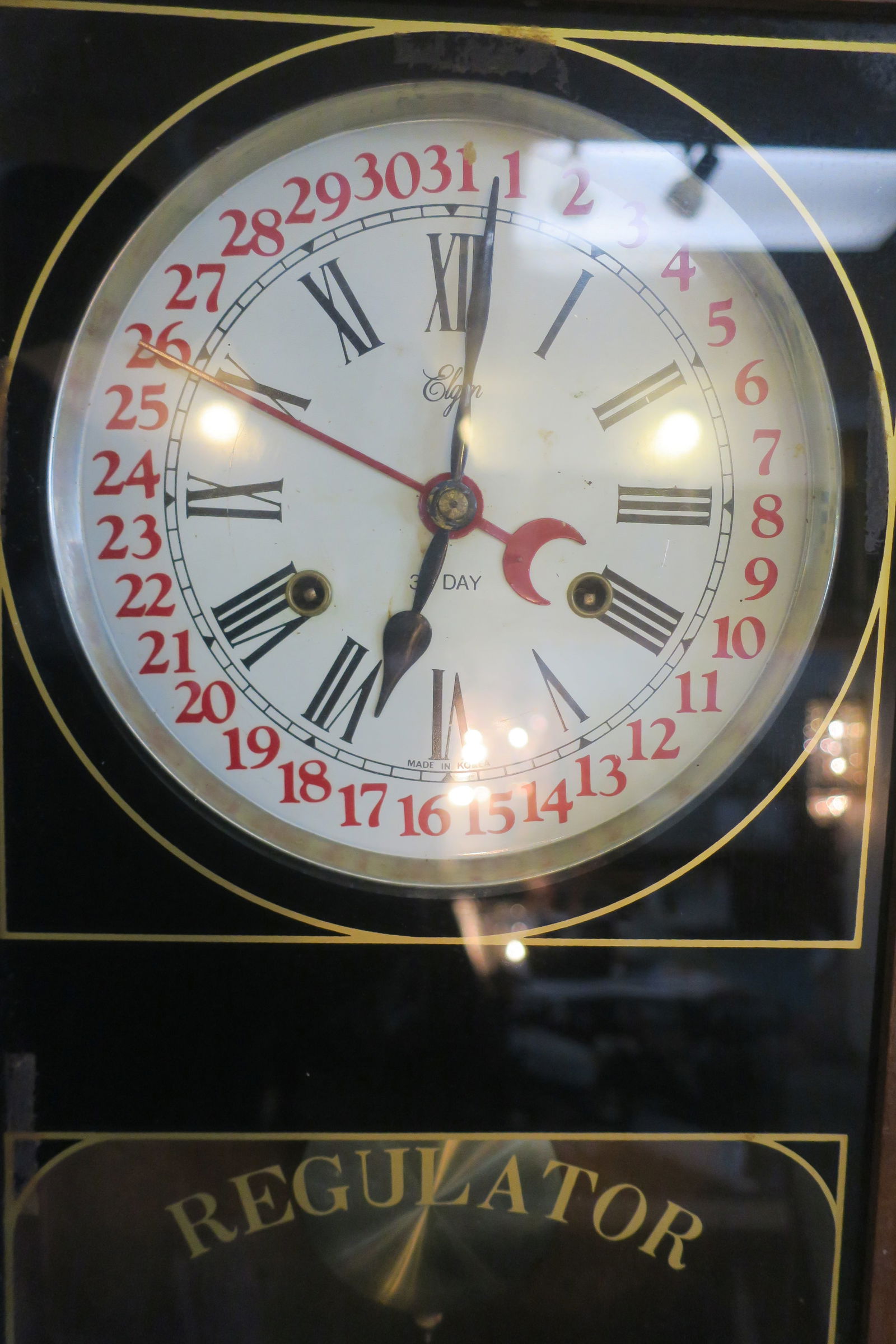 ELGIN Regulator 31 Day Wall Clock: Wood Cabinet, Glass Door with Black and Gold. 26 1/2"T, 14 1/2"W, 5"D. Needs Work. Has Key and Pendulum. Made in Korea.