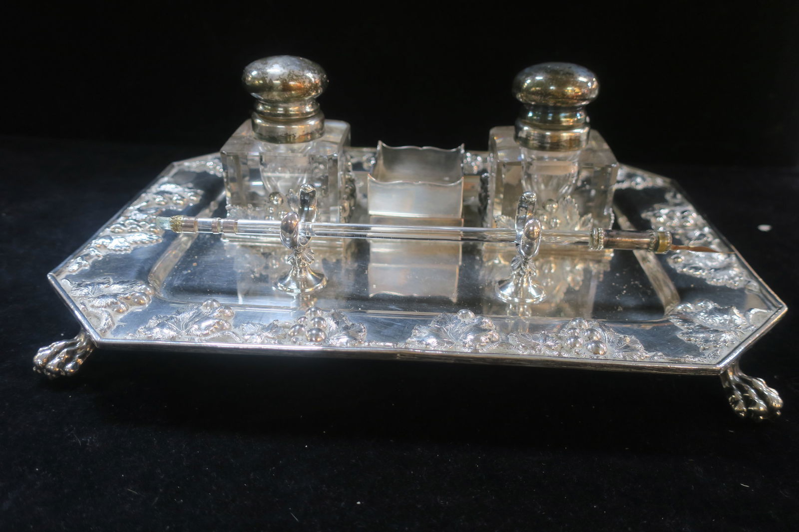Silver on Copper Sheffield Footed Inkstand: Rectangular Tray with Clipped Corners and applied Dimensional Grape Clusters on 4 Paw Feet Measures 8" X 11" 2 Square Glass Ink Pots with Hinged Lids are Beveled Along Edges. The Center Cup for Nibs L