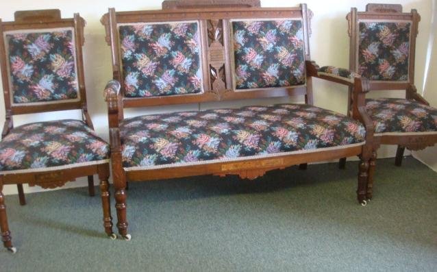 American Victorian Eastlake 3 Piece Parlor Set:: American Victorian Eastlake 3 Piece Parlor Set: Walnut Framed, 2 Side Chairs and Settee with Line and Spoon Carving. Settee has Open Floral Carved Center Panel. Ceramic Castors on Front Legs of Each P