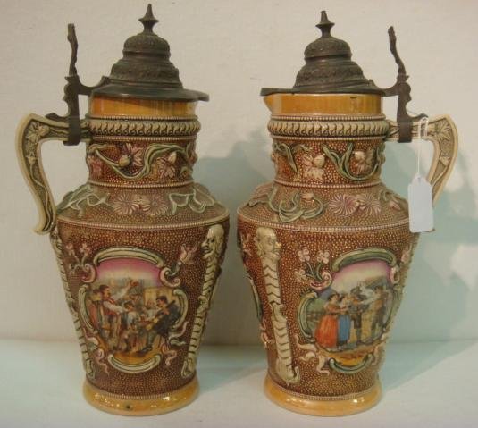 Pair of Antique German 12 3/4"T Stein Pitchers:: Pair of Antique German 12 3/4"T Stein Pitchers: Pewter Lidded Pitchers Marked Gesetzlich Geschutzt. One Also Marked DRGM Germany 154927. 3 Richly Colorful Cartoches with Folk and Drinking Scenes. Flor