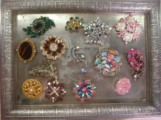 14 Vintage Costume Jewelry Pins on Pairpoint SP Tr: 14 Vintage Costume Jewelry Pins on Pairpoint SP Tray: One is Marked JJ. Another Star Made in Austria and One Marked Made in Germany. Silver-plate Tray has Double Stamp Mark of "Pairpoint Mfg. Co" Over