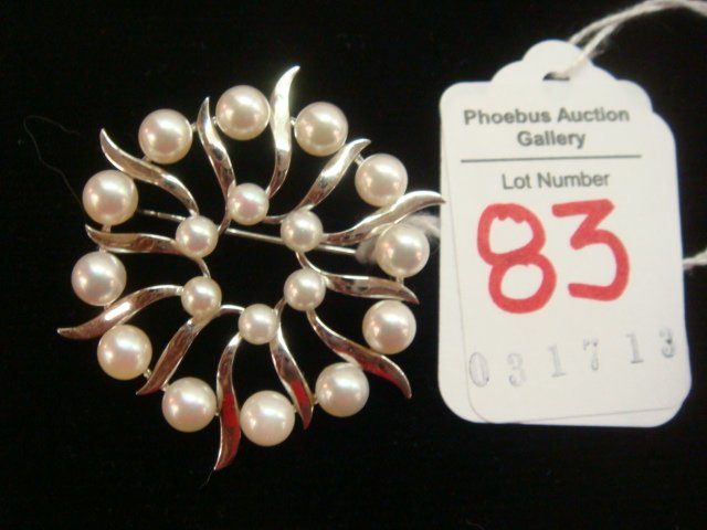 Sterling MIKIMOTO Pearl Starburst Pin:: Sterling MIKIMOTO Pearl Starburst Pin: 18 White Cultured Pearls Set in Sterling Silver and Spaced by Silver Leaves. Marked MS. 1 3/4" Diameter. Secure Roll Over Pin Back. (150-250)