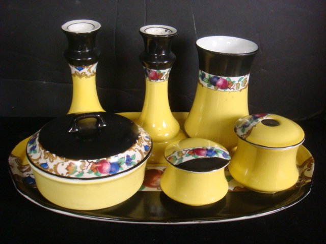 Seven Piece English Dresser Set:: Seven Piece English Dresser Set: Black and Yellow with Fruit Transfer Band. Includes110 15" Tray, 6" Lidded Powder Jar, 2 1/4" Lidded Jar,200 3" Hair Receiver, 5 1/2" Vase and Pair of 6 1/4" Candlesti