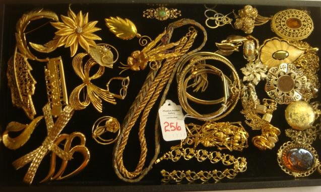 Ladies Goldtone Costume Jewelry:: Ladies Goldtone Costume Jewelry: 5 Pendants, One Ladies Watch and Another with 1907 Indian Head Penny. 12 Lapel Pins, Monet, Coventry, Trifari and Napier. Mesh and Rope Necklaces, Clip and Pierced Ear