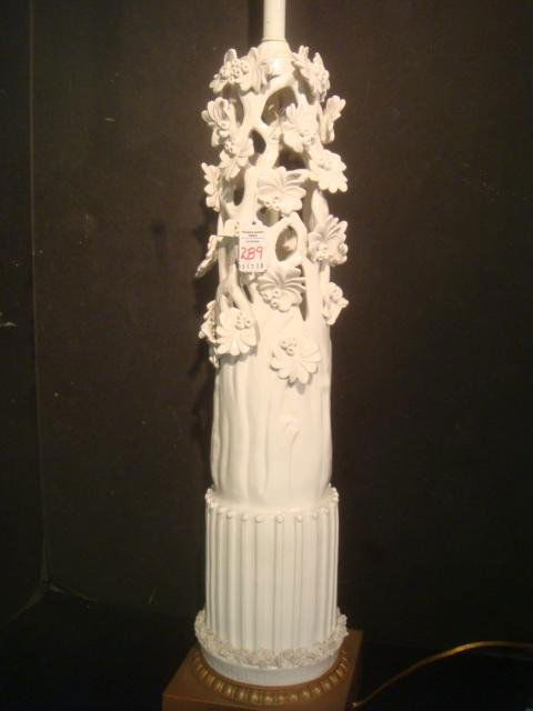 Reticulated Porcelain Tree Trunk Lamp:: Reticulated Porcelain Tree Trunk Lamp: Applied Petal Flowers and Berries. Fluted Base with Spagetti Trim. Square Gold Base with Bead Trim Accent. 34 1/4"T, to Socket. (100-200)