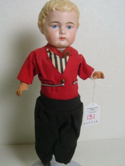 1880's German Bisque Shoulder Head Boy Doll:: 1880's German Bisque Shoulder Head Boy Doll: Papier Mache Body, 10"T. Solid Dome with Molded Blond Curled Hair and Painted Features. Dressed in Dutch Boy Outfit. Missing Right Thumb. (150-200)