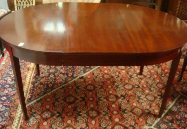 BIGGS Solid Inlaid Mahogany Round Dining Table:: BIGGS Solid Inlaid Mahogany Round Dining Table: 4 Hepplewhite Style tapered Legs. Line Inlay Around Top, Apron and Down Legs. Burned in Biggs Brand. 30"T X 41"W X 60"L with Leaf Inserted. Extra Leaf. 
