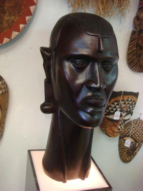 Hand carved Ebony Hard Wood Bust of African Male:: Hand carved Ebony Hard Wood Bust of African Male: Misaim Warrior Carved From Single Piece of Wood is 23"T Standing. Elongated Lobes with Earrings, Line Carved Hair with Side Braids. (600-900)