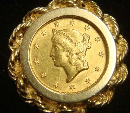1853 US Gold One Dollar Liberty Head Coin:: 1853 US Gold One Dollar Liberty Head Coin: MS 60+ Gold Coin Mounted in Ornate 14KT Bezel Setting with 26 1/8" Rope Link Chain weighing 11.8 Grams (8.9 DWT). Collector Quality Coin with Very Good Tone 