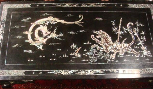 Asian Black Lacquer Mother of Pearl Coffee Table:: Asian Black Lacquer Mother of Pearl Coffee Table: Handmade with Intricate Patterns by Skilled Master Carver Creating the Traditional 5 Claw Dragon and Tiger Scene on Top. They Represent Yin and Yang,
