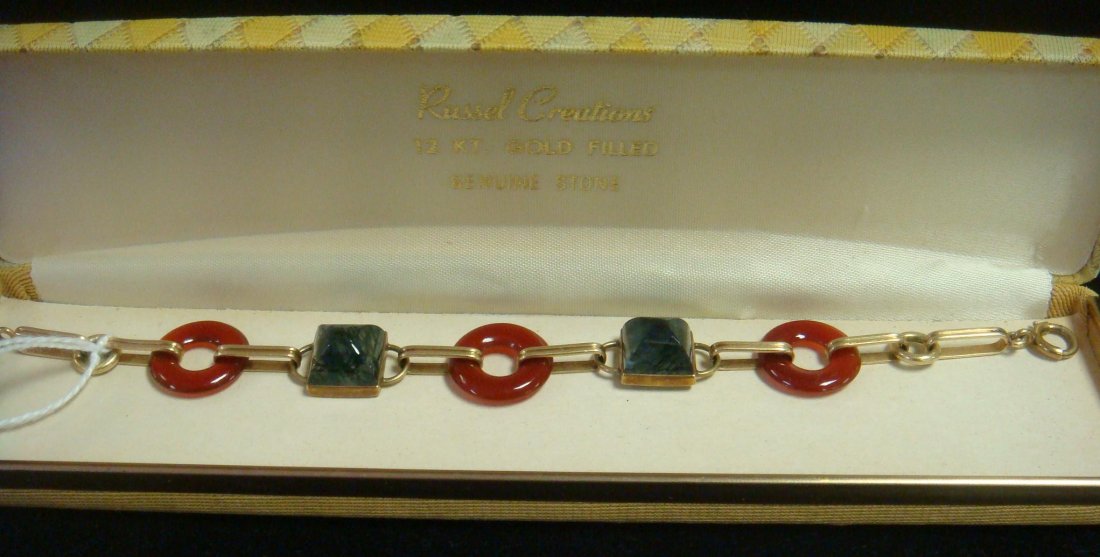 Tourmaline Quartz and Carnelian 14KT Bracelet: Tourmaline Quartz and Carnelian 14KT Bracelet 7 3/4"L Donut Shaped Carnelian Separated by Domed Brazilian Quartz with Black Tourmaline Striations. Connected with Elongated 14KT Links. Marked on Clasp.