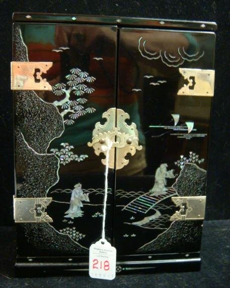 Black Lacquer Mother of Pearl Music/Jewelry Box:: Black Lacquer Mother of Pearl Music/Jewelry Box: Double Doors Open to 3 Drawer Velvet Lined Interior with Music Box. Brass Bell Flower Pulls, Hinges and Latch. Asian Scene on Exterior Doors. (100-200)
