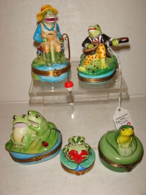 Five Frog Theme Hand Painted Limoges Boxes:: Five Frog Theme Hand Painted Limoges Boxes: Frog Playing Banjo, 2"T, Frog with Heart, 1 7/8"T, Frog on Lily Pad, 2 1/8"T, Two Frogs with a Lady Bug, 2 1/2"T, Fishing Frog with Pole, 2 1/8"T. (300-400)